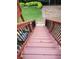 Wooden stairs with black metal railings lead to the backyard at 1105 River Laurel Dr, Suwanee, GA 30024