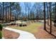 Picturesque view of a neighborhood street with beautifully landscaped yards and elegant homes, exuding charm and curb appeal at 1105 River Laurel Dr, Suwanee, GA 30024