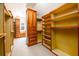 An expansive walk-in closet with custom built-in shelving and cabinetry at 1105 River Laurel Dr, Suwanee, GA 30024