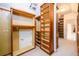 Large walk-in closet with custom wood shelving and a small storage room at 1105 River Laurel Dr, Suwanee, GA 30024