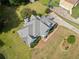 The aerial view highlights the house, its expansive roof, well-maintained landscape and outdoor living space at 180 Butterfield Ln, Fayetteville, GA 30214
