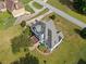 An aerial view reveals the home's layout, deck, manicured lawn, and mature trees on the property at 180 Butterfield Ln, Fayetteville, GA 30214