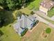 An aerial view of a home with a large yard, mature trees, and driveway leading to a three-car garage at 180 Butterfield Ln, Fayetteville, GA 30214