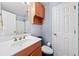 Bathroom featuring a wooden vanity and cabinet, plus a white toilet and shower at 180 Butterfield Ln, Fayetteville, GA 30214