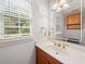 Bright bathroom featuring a wooden vanity and gold fixtures at 180 Butterfield Ln, Fayetteville, GA 30214