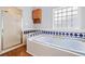 Bathroom featuring a tiled whirlpool tub, glass shower, and a decorative window at 180 Butterfield Ln, Fayetteville, GA 30214