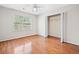 Bright bedroom with hardwood floors, closet, and large windows at 180 Butterfield Ln, Fayetteville, GA 30214