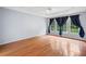 Primary bedroom featuring hardwood floors, tray ceiling, and window at 180 Butterfield Ln, Fayetteville, GA 30214