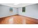Well lit bedroom featuring hardwood floors and two windows at 180 Butterfield Ln, Fayetteville, GA 30214