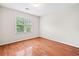 Well lit bedroom featuring hardwood floors and a window at 180 Butterfield Ln, Fayetteville, GA 30214