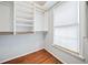 Walk-in closet with built-in shelving and hardwood floors at 180 Butterfield Ln, Fayetteville, GA 30214