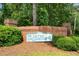 A brick entrance sign for Yates Crossing community, surrounded by lush greenery, offering a welcoming feel at 180 Butterfield Ln, Fayetteville, GA 30214