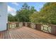 Spacious wooden deck overlooking the serene outdoors, with a decorative brown and white lattice railing at 180 Butterfield Ln, Fayetteville, GA 30214