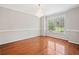 Light-filled dining room with hardwood floors, chair rail detail, and large window at 180 Butterfield Ln, Fayetteville, GA 30214
