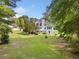 A view of the home from the spacious backyard, showcasing the deck, windows, and well-kept lawn at 180 Butterfield Ln, Fayetteville, GA 30214