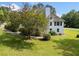 Picturesque home with manicured lawn and mature trees, providing a tranquil and inviting atmosphere at 180 Butterfield Ln, Fayetteville, GA 30214