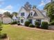 Well-maintained home featuring neat landscaping, a spacious lawn, and a charming architectural design at 180 Butterfield Ln, Fayetteville, GA 30214