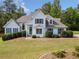 Attractive home with blue shutters, set against a lush green lawn and surrounded by mature trees at 180 Butterfield Ln, Fayetteville, GA 30214