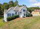 Beautiful home with blue shutters, complemented by lush landscaping, creating a serene curb appeal at 180 Butterfield Ln, Fayetteville, GA 30214