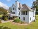 Two-story home exterior featuring a deck, white siding, well-maintained landscaping, and a manicured lawn at 180 Butterfield Ln, Fayetteville, GA 30214