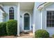 Inviting front door with decorative glass and classic arch window that complements the light blue exterior at 180 Butterfield Ln, Fayetteville, GA 30214