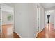 Hallway featuring beautiful hardwood floors and multiple doorways leading to other rooms within the home at 180 Butterfield Ln, Fayetteville, GA 30214