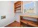 Laundry area with built in wooden shelves and hardwood flooring at 180 Butterfield Ln, Fayetteville, GA 30214