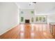 Spacious living room with hardwood floors, a fireplace, large windows, and access to the backyard at 180 Butterfield Ln, Fayetteville, GA 30214