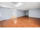 Spacious room with hardwood floors and neutral walls with doorway offering versatile living space at 180 Butterfield Ln, Fayetteville, GA 30214