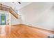 Bright living room featuring hardwood floors, tall ceilings, a staircase, and a decorative front door at 180 Butterfield Ln, Fayetteville, GA 30214