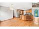 Spacious living room with hardwood floors, leading to a well-appointed kitchen and staircase at 180 Butterfield Ln, Fayetteville, GA 30214