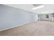 Living room featuring carpet, two windows and an exit door at 180 Butterfield Ln, Fayetteville, GA 30214