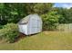 Backyard shed with double doors and surrounding greenery at 180 Butterfield Ln, Fayetteville, GA 30214