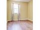 Cozy bedroom with wood floors, bright window, and soft natural light at 2211 Jonathan Ave, Lithonia, GA 30058