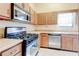 Modern kitchen with stainless steel appliances, gas range, and sleek countertops at 2211 Jonathan Ave, Lithonia, GA 30058