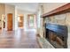 Open living room with hardwood flooring, a stone fireplace, and a decorative front door at 2211 Jonathan Ave, Lithonia, GA 30058
