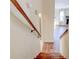 View down wooden stairs with light walls and hardwood floors leading to living area at 2211 Jonathan Ave, Lithonia, GA 30058