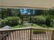 The covered porch overlooks a backyard with a custom wood pergola and lush landscaping at 395 Russell Sw Dr, Smyrna, GA 30082