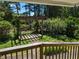 The covered porch provides a view of the backyard with a custom wood pergola and lush landscaping at 395 Russell Sw Dr, Smyrna, GA 30082