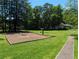Inviting backyard featuring mature trees, a swing set, and a basketball hoop for outdoor activities at 395 Russell Sw Dr, Smyrna, GA 30082