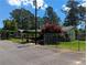 The exterior of this building offers covered parking and landscaped grounds on a sunny day at 395 Russell Sw Dr, Smyrna, GA 30082