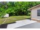 A lush green backyard features a newly built concrete patio and a storage shed at 624 Lyle Se Dr, Marietta, GA 30067