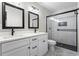 Modern bathroom features double sink vanity, black hardware, and large shower with glass door and black accents at 624 Lyle Se Dr, Marietta, GA 30067