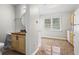 Compact bathroom features a wood vanity, round mirror, and tile flooring at 624 Lyle Se Dr, Marietta, GA 30067