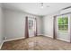 Spacious bedroom featuring ceiling fan, tiled floors, and ample natural light from two windows at 624 Lyle Se Dr, Marietta, GA 30067
