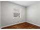 Bright bedroom features hardwood floors, and a large window offering natural light at 624 Lyle Se Dr, Marietta, GA 30067