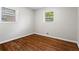Cozy bedroom with hardwood floors, two windows, and neutral paint creates a serene space at 624 Lyle Se Dr, Marietta, GA 30067
