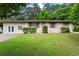 Charming single-story home featuring a well-maintained lawn and lush greenery at 624 Lyle Se Dr, Marietta, GA 30067
