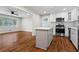 Open kitchen layout with view to the living room, stainless appliances, white cabinetry, island at 624 Lyle Se Dr, Marietta, GA 30067