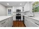 Bright kitchen with white cabinets, stainless steel appliances, and a kitchen island at 624 Lyle Se Dr, Marietta, GA 30067